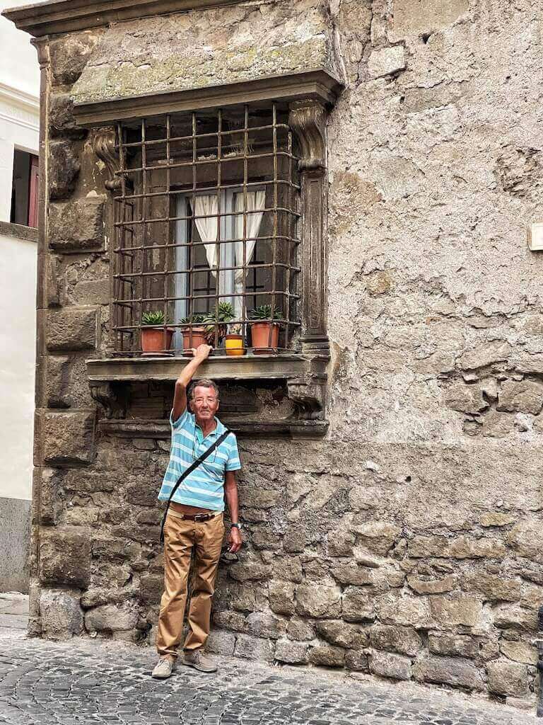 My dad posing under the window of the place where he grew up in Viterbo