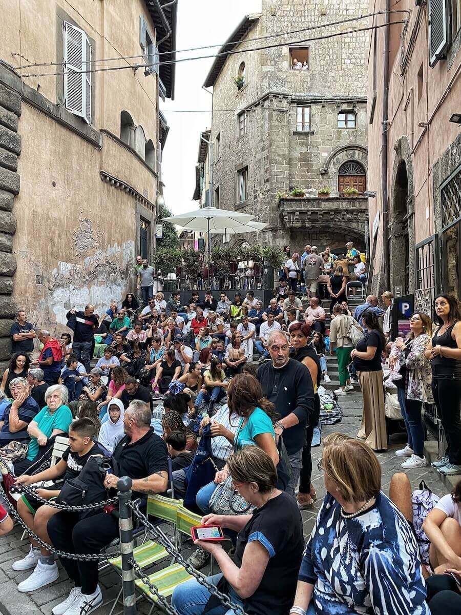 Crowds sitting along the streets of Viterbo, waiting for the parade.